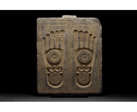 Ca. 100–200 AD. A grey chlorite-schist rectangular panel, carved with the impressed footprints of the Buddha. Each footprint 