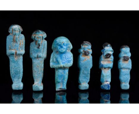 Ca. 664 - 32 B.C. Late Dynastic to Ptolemaic Period. Egyptian. An ancient Egyptian mummiform ushabti group wearing a plain tr