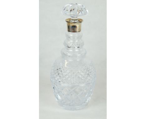 A silver and cut-glass wine decanter
Of baluster form, with a cut-glass stopper with a plain silver crested collar, by Garrar