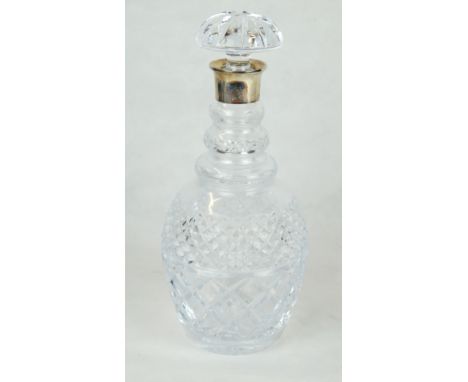 A silver and cut-glass wine decanter
Of baluster form, with a cut-glass stopper with a plain silver crested collar, by Garrar