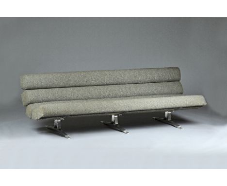 20th century design; a grey upholstered sofa, with tubular cushions on polished steel supports, 210cm wide x 65cm high. Illus