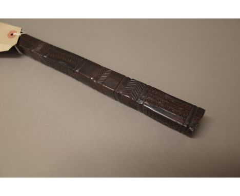 A South Sea Islands hardwood long stick or staff, with geometric carved decoration to the square form head (158cm) and a Sout