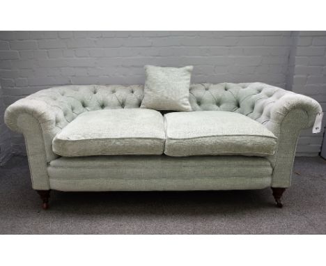 An early 20th century pale teal button back Chesterfield sofa, on bun feet, 180cm wide x 72cm high.