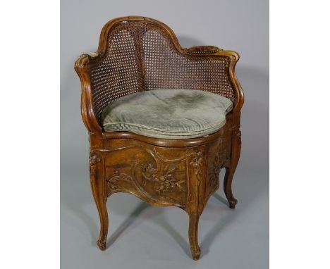 A Louis XV style beech commode chair. 