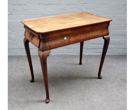 An 18th century and later mahogany silver table, the dished rectangular top with re-entrant corners, the cushion frieze with 