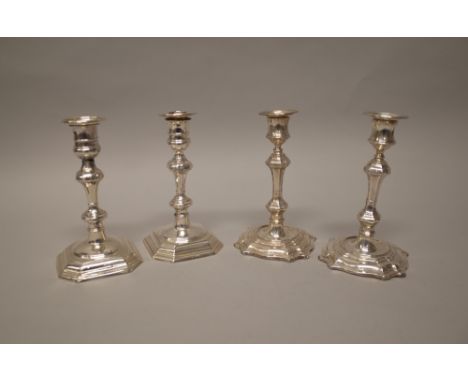 A pair of silver table candlesticks, each with a knopped stem, raised on a cut cornered square base, the hallmarks rubbed, he