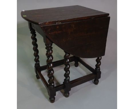 A late 18th century oak gateleg console table on barleytwist supports, 67cm wide x 78cm high. 