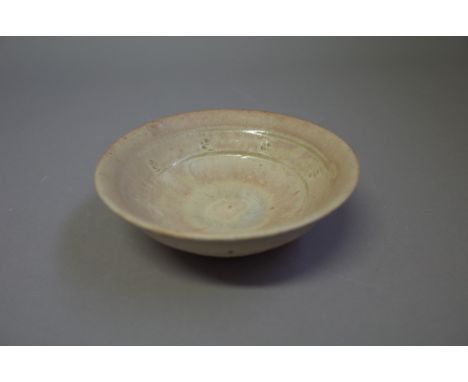 Jim Malone (born 1946), an open dish with yellow ash glaze, Ainstable period, makers marks, 15cm diameter.  DDS