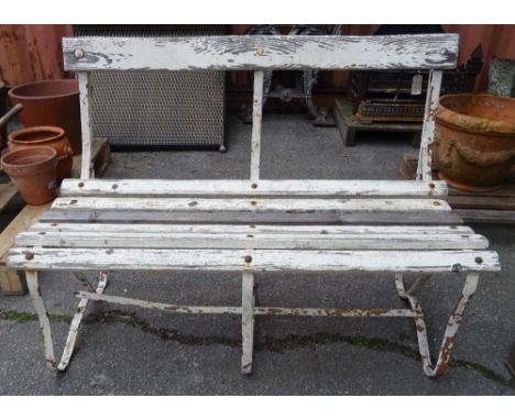 An early 20th century white painted strap iron garden bench, 107cm wide x 75cm high. 