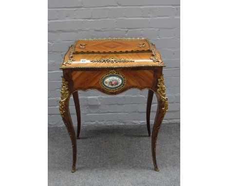 A late 19th century gilt metal and ceramic mounted Kingwood jardiniere, of serpentine outline on cabriole supports, 65cm wide
