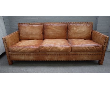 A mid-20th century three seater studded brown leather upholstered square back sofa, 203cm wide x 80cm high. 