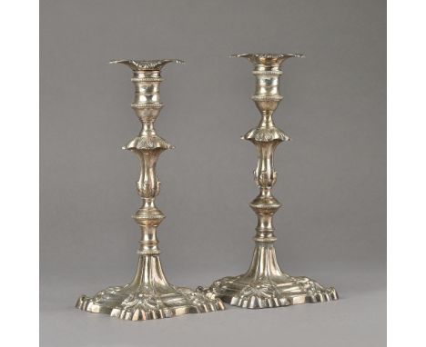 A pair of late George II silver table candlesticks, each of cast form, with a knopped stem, on a shaped square base decorated