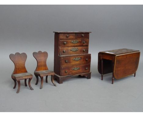 A suite of miniature furniture, to comprise; a dresser 17cm wide x 22cm high, a Regency drop flap table 20cm wide x 14cm high