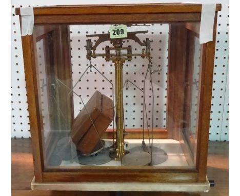 An early 20th century mahogany cased set of chemist's balance scales. 