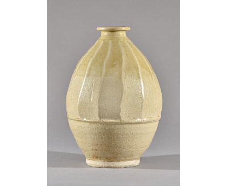 Jim Malone (born 1946), a thrown and shaped form with celadon glaze, maker and studio marks, 30cm high.  DDS Illustrated. 