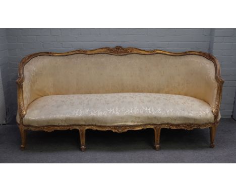 A Louis XVI style gilt framed sofa with shaped back and double serpentine seat, 215cm wide x 93cm high.