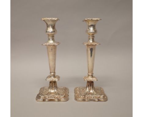 A pair of silver table candlesticks, each of shaped squared form, having tapering stems, raised on a shaped square base, Shef