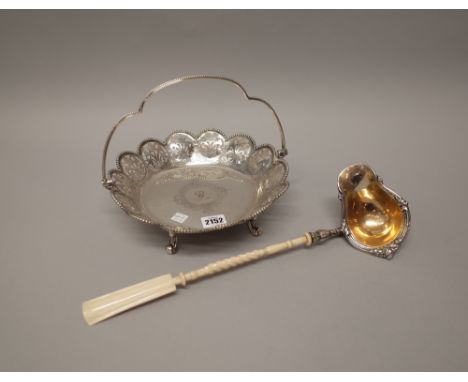 A Victorian silver cake or fruit basket, of shaped circular form, decorated with floral pierced panels, within an undulating 