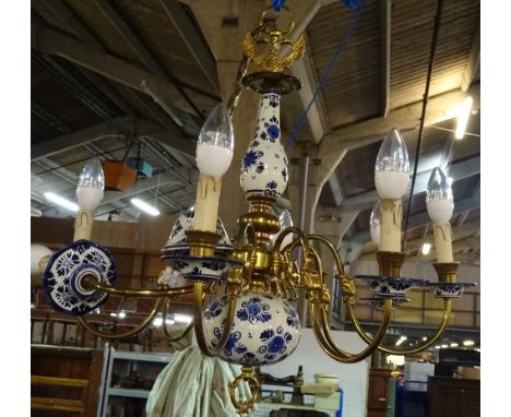 A Dutch style brass and blue and white ceramic eight light chandelier, 70cm wide.