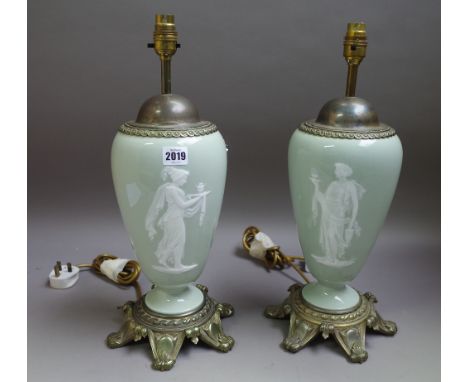 A pair of pâte-sur-pâte celadon-ground gilt-metal mounted table lamps, late 19th/early 20th century, each decorated with a cl