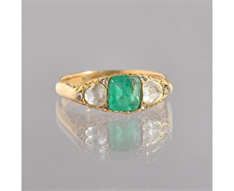 A gold, emerald and diamond ring, mounted with the square cut emerald to the centre, between the two principle rose cut diamo