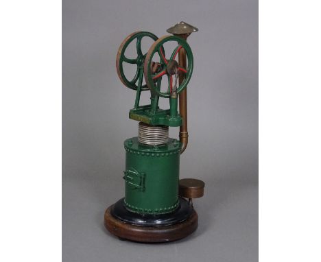 A live vertical hot air engine, green livery with title plate 'HEINRICI', copper boiler and flue on a wooden circular base, 4