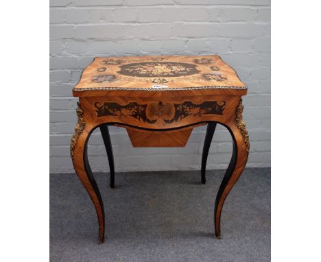 A late 19th century French lift top work table, of serpentine outline, on cabriole supports, 65cm wide x 76cm high.