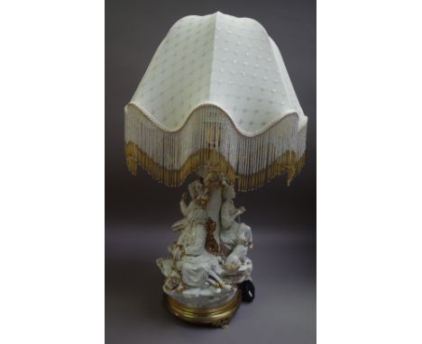 A Capodimonte porcelain figural table lamp on a gilt metal circular base and with shaped beadwork shade, blue imprinted mark,