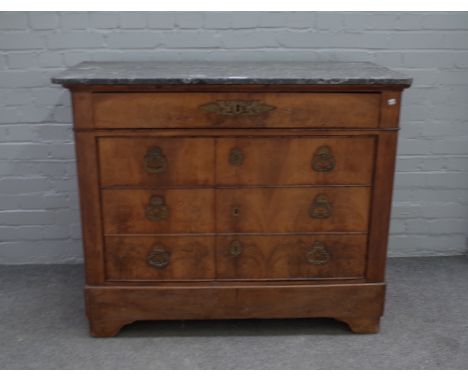 An early 19th century French commode, the marble top over one long drawer and pair of cupboards fronted as three long drawers