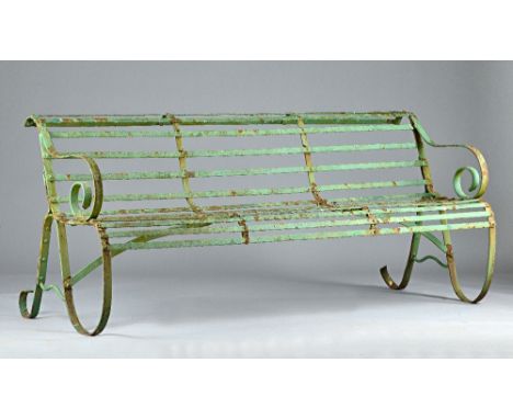 A late 19th century green painted wrought iron bench of Regency design, 182cm wide x 80cm high. Illustrated. 