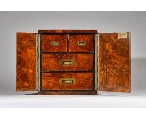 A Victorian brass bound figured walnut table top cabinet, the pair of doors enclosing two short and two long drawers, 30cm wi