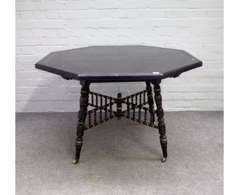 Howard and Sons; a Victorian parcel gilt ebonised octagonal centre table, on turned supports, 108cm wide x 69cm high.