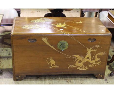 Oriental hardwood trunk decorated with figures, 57cm by 105cm.
