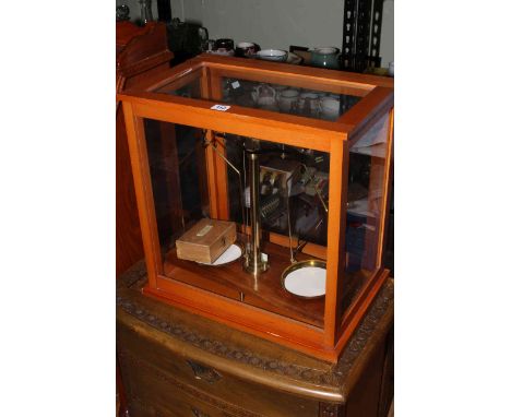 Set of cased balance scales with weights, 49cm by 46cm.