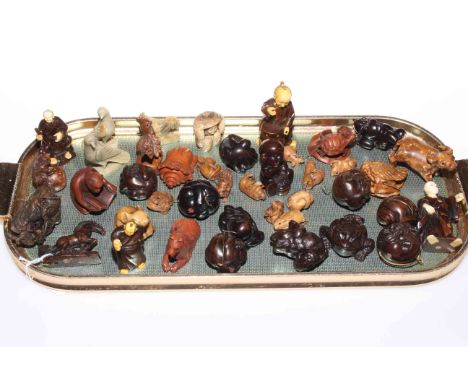 Collection of over forty netsuke, small figures, hardstone and wood carvings.