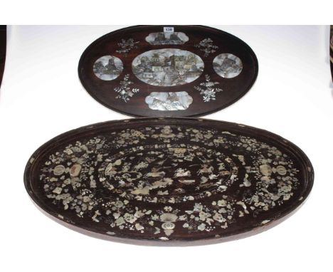 Two Oriental oval trays and inlaid with mother of pearl.