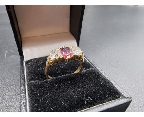 A yellow metal garnet and diamond three stone ring, stamped 18ct, size O, gross weight 3.9g. (please note description changed