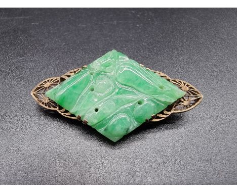 A Chinese yellow metal brooch, set triangular jade plaque carved fruit, 44mm. 