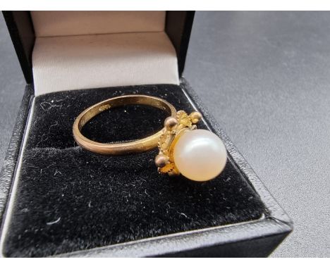 A yellow metal ring set single pearl, stamped 14k, size N. 