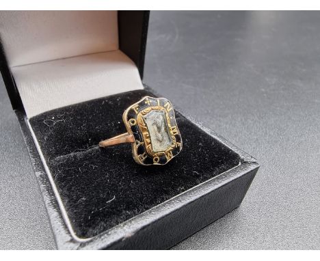 A 19th century yellow metal and black enamel mourning ring,&nbsp;inscribed 'In Memory Of' set lock of woven hair, size F. 