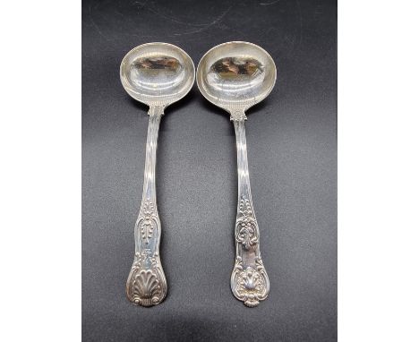 A William IV silver Kings pattern with Union shell sauce ladle, London 1835; together with a similar Victorian Kings pattern 