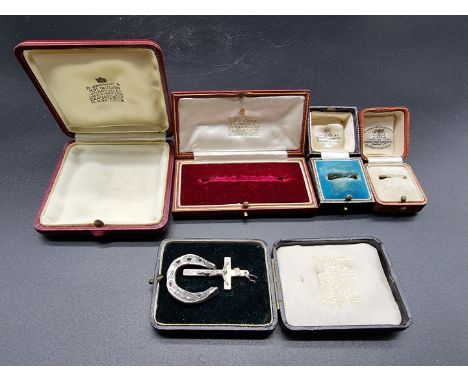 Two Garrard &amp; Co jewellery boxes; together with two ring boxes; a cased crucifix, stamped silver; and a metal miniature h