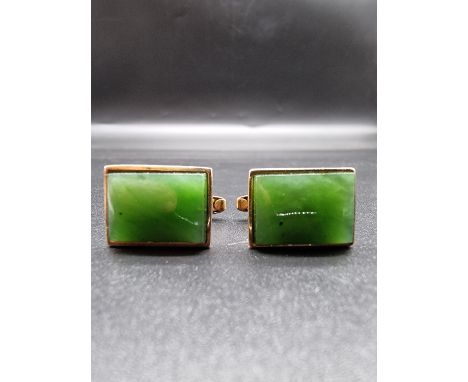 A pair of yellow metal cufflinks, set rectangular jade panels, 22 x 12mm, stamped 9ct. 