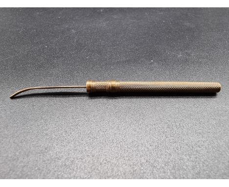 An S Mordan &amp; Co engine turned yellow metal propelling toothpick, 5cm closed. 