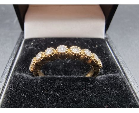 A yellow metal diamond half eternity ring, stamped 14k, size N. 