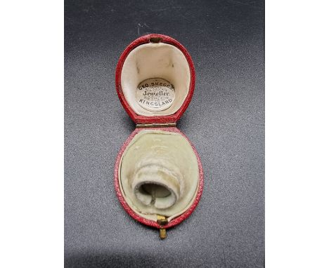 A Victorian red leather horseshoe shaped ring box, inscribed 'Geo Skeggs Jeweller, Kingsland'.