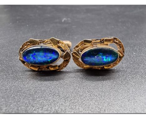 A pair of yellow metal oval cufflinks, each set oval dark opal, 14 x 8mm, stamped 10k. 