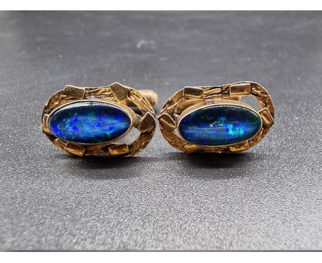 A pair of yellow metal oval cufflinks, each set oval dark opal, 14 x 8mm, stamped 10k. 