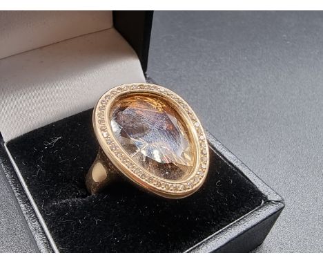 An 18ct gold ring, set organic shaped faceted citrine surrounded by a border of diamonds, by G P Ltd, Sheffield 2017, gross w