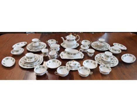 A floral pattern gilt edged dinner service, including dinner plates, side plates, sauce boat and stand, soup cups, bread and 